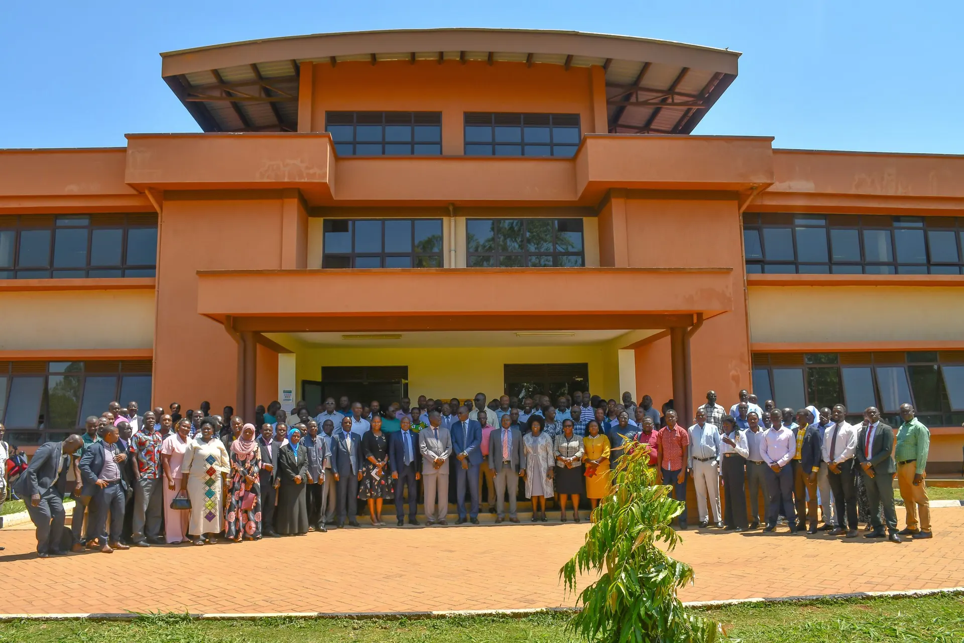 Gulu University staff gathered in front of a university building