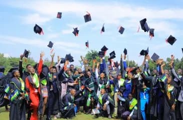 Kyambogo University graduates throwing their caps