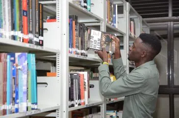 A student in the Kyambogo University library