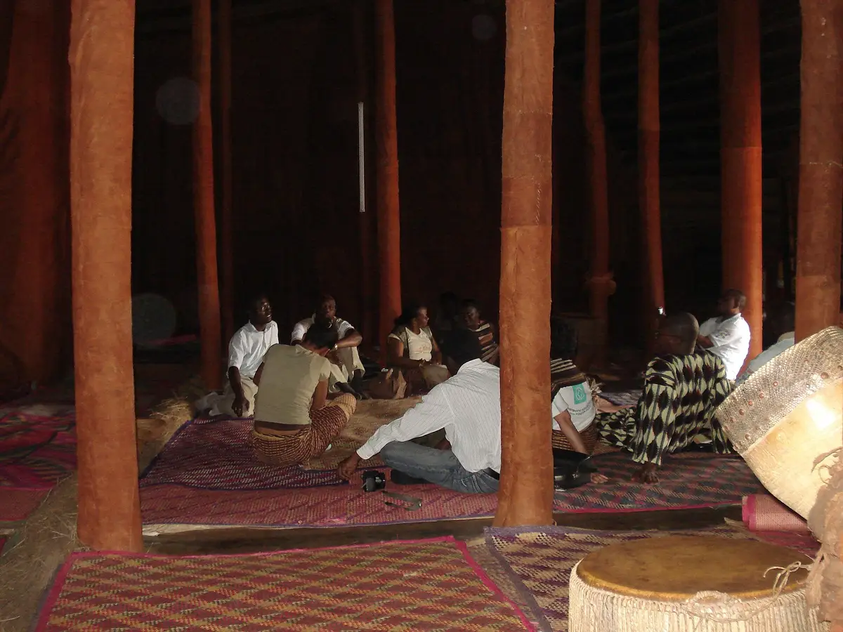 Custodians seated inside the Kasubi tomb house