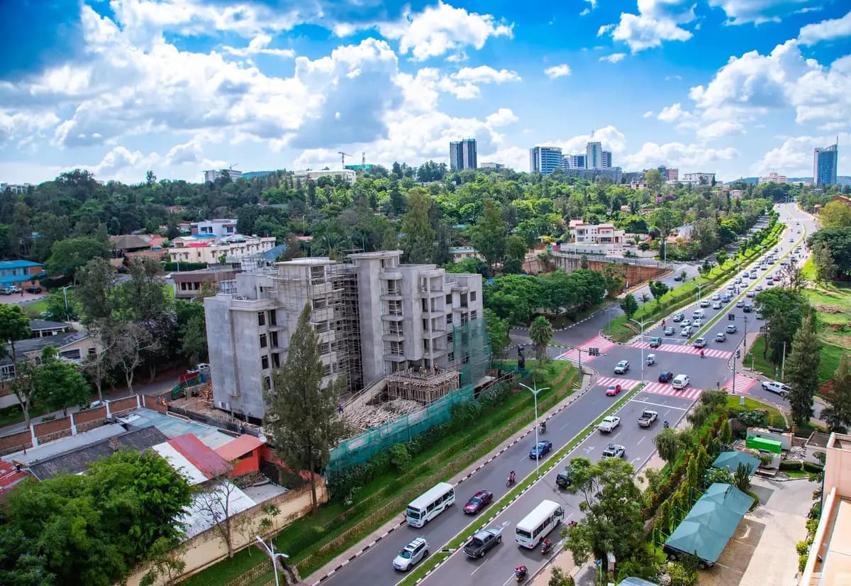 Motorbikes and cars on a tree-lined boulevard in Kigali