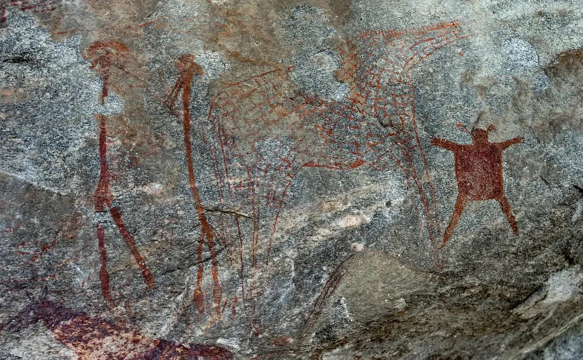 Red ochre human and animal figures in a Kondoa rock shelter