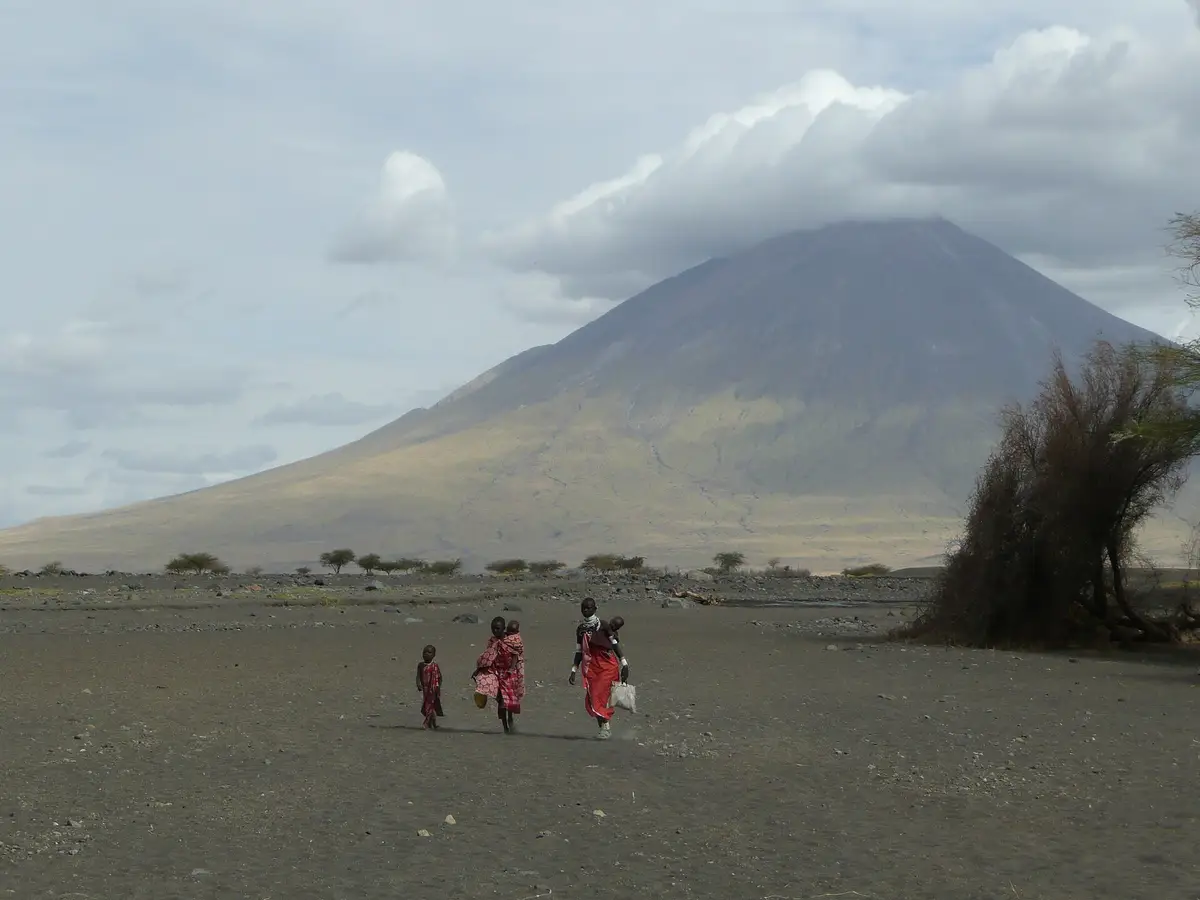 Maasai walking across the plain below Ol Doinyo Lengai