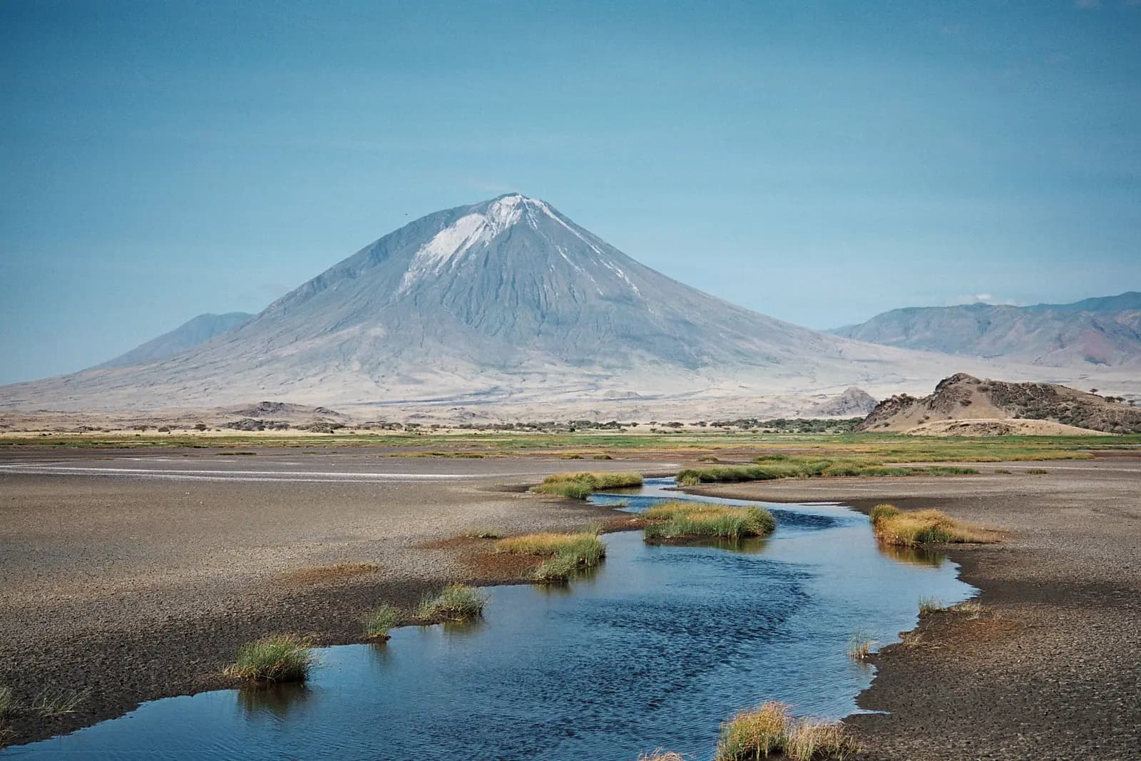 Ol Doinyo Lengai volcano above the shores of Lake Natron