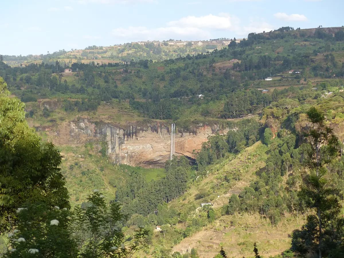 Sipi Falls seen across a green valley